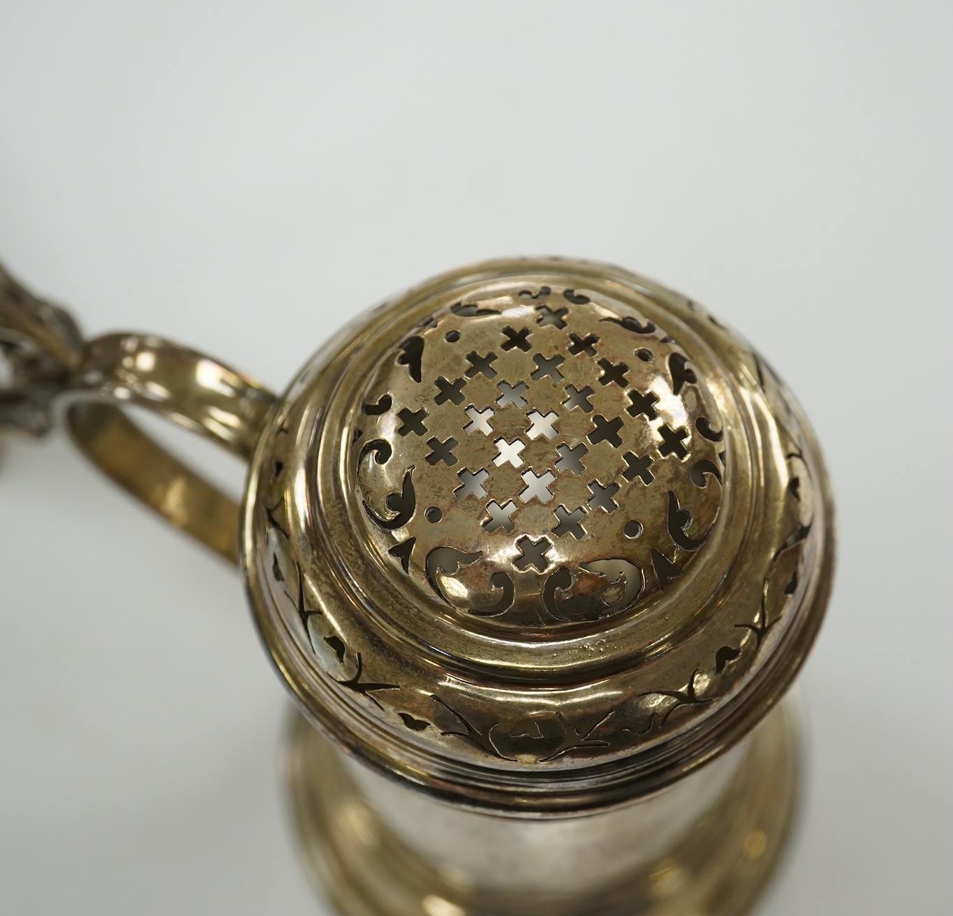 A George V Brittania standard silver kitchen pepper, by John Charles Lowe, London, 1935, 11.5cm and a Victorian silver christening mug, 10.4oz. Condition - poor to fair